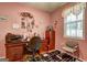 Bright office with wood desk and a decorative motif on the pink walls at 260 Sams Dr, Fayetteville, GA 30214