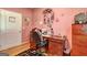 Inviting office with wood desk and a decorative motif on the pink walls at 260 Sams Dr, Fayetteville, GA 30214