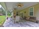 The covered outdoor patio with ceiling fans, table, chairs, and outdoor grill at 260 Sams Dr, Fayetteville, GA 30214