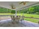 Covered patio with chairs, ceiling fans, and a great backyard view at 260 Sams Dr, Fayetteville, GA 30214