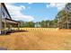 Expansive backyard featuring a well-maintained lawn and view of the house with covered porch at 3735 Tamiami Trl, Cumming, GA 30041