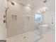 A large bathroom with a glass shower, mosaic tiles, and a soaking tub at 3735 Tamiami Trl, Cumming, GA 30041