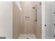 This modern shower features tile walls, a glass door, a rain shower head, and a built in shower caddy at 3735 Tamiami Trl, Cumming, GA 30041