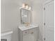 Elegant bathroom with a stylish vanity, decorative mirror, and modern fixtures at 3735 Tamiami Trl, Cumming, GA 30041