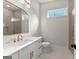 Modern bathroom with white cabinets, gold fixtures, and a tiled shower with a glass door at 3735 Tamiami Trl, Cumming, GA 30041