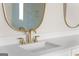 Close up on bathroom sink with white countertop and gold fixtures at 3735 Tamiami Trl, Cumming, GA 30041