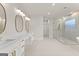 Bright bathroom with double vanity, modern sinks, large mirrors, walk-in shower, and a soaking tub at 3735 Tamiami Trl, Cumming, GA 30041