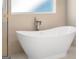 Modern bathtub with elegant fixture and detailed shower wall at 3735 Tamiami Trl, Cumming, GA 30041