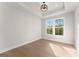 Cozy bedroom featuring a tray ceiling and a bright window at 3735 Tamiami Trl, Cumming, GA 30041