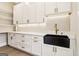Butler's pantry featuring white cabinetry, quartz counters, undermount lighting and black sink at 3735 Tamiami Trl, Cumming, GA 30041
