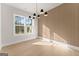 Bright dining room with modern light fixture, hardwood floors, and large windows for natural light at 3735 Tamiami Trl, Cumming, GA 30041