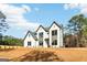 Charming home with modern farmhouse design, set against a backdrop of lush greenery at 3735 Tamiami Trl, Cumming, GA 30041