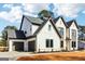 Spacious three-car garage with dark doors complementing the home's exterior at 3735 Tamiami Trl, Cumming, GA 30041
