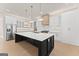 Modern kitchen boasts a large island, stainless steel appliances, and elegant pendant lighting at 3735 Tamiami Trl, Cumming, GA 30041