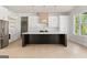 Modern kitchen features white cabinets, a black island, stainless steel appliances, and luxury fixtures at 3735 Tamiami Trl, Cumming, GA 30041