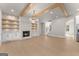 Spacious living room with fireplace, built-ins, wood beams and a stylish light fixture at 3735 Tamiami Trl, Cumming, GA 30041