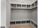 Mudroom with coat hooks, shelving, and space to sit while taking off shoes at 3735 Tamiami Trl, Cumming, GA 30041