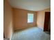 Cozy bedroom featuring neutral colored walls and carpet, plus a large window for natural light at 102 Crystal River Dr, Riverdale, GA 30274