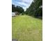 Expansive backyard featuring a storage shed, a large lawn, and privacy trees at 7340 Chalk Way, Riverdale, GA 30296