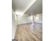 An open basement space with wood-look flooring, white walls, and a window at 7340 Chalk Way, Riverdale, GA 30296