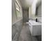 A bathroom features modern gray tile, and a white vanity with drawers and a stone countertop at 7340 Chalk Way, Riverdale, GA 30296