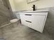 A bathroom features modern gray tile, and a white vanity with drawers and a stone countertop at 7340 Chalk Way, Riverdale, GA 30296