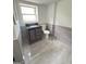 Contemporary bathroom with vanity, toilet, and gray tiled walls at 7340 Chalk Way, Riverdale, GA 30296