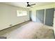 Bright, carpeted bedroom with a ceiling fan and large closets at 7340 Chalk Way, Riverdale, GA 30296