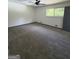 Carpeted bedroom featuring a ceiling fan and natural light from a bright window at 7340 Chalk Way, Riverdale, GA 30296