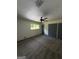 Spacious carpeted bedroom with a ceiling fan, window, and ample closet space at 7340 Chalk Way, Riverdale, GA 30296