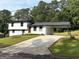 Charming two-story home with a manicured lawn, a carport, and freshly painted exterior at 7340 Chalk Way, Riverdale, GA 30296