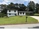 Charming two-story home with a well-manicured lawn and convenient carport at 7340 Chalk Way, Riverdale, GA 30296