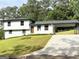 Charming two-story home with a manicured lawn, a carport, and freshly painted exterior at 7340 Chalk Way, Riverdale, GA 30296