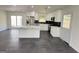 Open-concept kitchen featuring a center island, stainless appliances, and white cabinets at 7340 Chalk Way, Riverdale, GA 30296