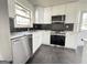 Modern kitchen featuring stainless steel appliances and white cabinets at 7340 Chalk Way, Riverdale, GA 30296