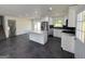 Bright, modern kitchen features white cabinets, stainless appliances, and island at 7340 Chalk Way, Riverdale, GA 30296