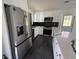 Updated kitchen with stainless steel appliances, white cabinetry, and a center island at 7340 Chalk Way, Riverdale, GA 30296