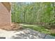 Lush backyard featuring manicured lawn, mature trees, and concrete patio at 315 Antebellum Way, Fayetteville, GA 30215