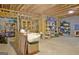 Partially finished basement with wood beams, block wall, filled with furniture and storage containers at 315 Antebellum Way, Fayetteville, GA 30215