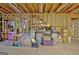 Unfinished basement with open wood beams and piled storage boxes at 315 Antebellum Way, Fayetteville, GA 30215