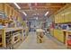 Unfinished basement has exposed ductwork, wood beams, and work tables lining the walls at 315 Antebellum Way, Fayetteville, GA 30215