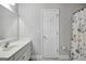 Bathroom with tile floors, features a vanity with drawers and a mirror with vanity lighting at 315 Antebellum Way, Fayetteville, GA 30215