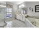 This bathroom features a double vanity, a soaking tub, and a glass-enclosed shower for convenience at 315 Antebellum Way, Fayetteville, GA 30215