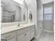 Bright bathroom with white vanity, large mirror, and tiled floors at 315 Antebellum Way, Fayetteville, GA 30215