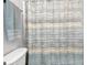 Bathroom featuring tiled walls, shower curtain, and toilet at 315 Antebellum Way, Fayetteville, GA 30215