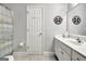 Neutral bathroom featuring a vanity, mirror, and tiled floors at 315 Antebellum Way, Fayetteville, GA 30215