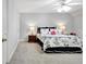 Comfortable bedroom with carpet floors and featuring a bed with floral pattern bedding and matching furniture at 315 Antebellum Way, Fayetteville, GA 30215