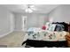 Bedroom with carpet floors and featuring a bed with floral pattern bedding and a partially visible adjacent bathroom at 315 Antebellum Way, Fayetteville, GA 30215