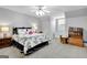 Comfortable bedroom features carpet floors, a ceiling fan, and a window seat with built in storage at 315 Antebellum Way, Fayetteville, GA 30215