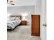 Bright bedroom with carpet, ceiling fan, and a bed with striped bedding at 315 Antebellum Way, Fayetteville, GA 30215
